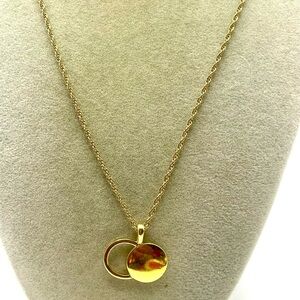 Gold Tone Open Circle and Solid Disc Pendant on a Rope Necklace. 18 inches